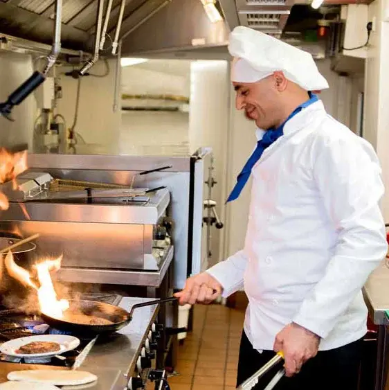 Parker Place Chef Created Meals, chef frying a dish.