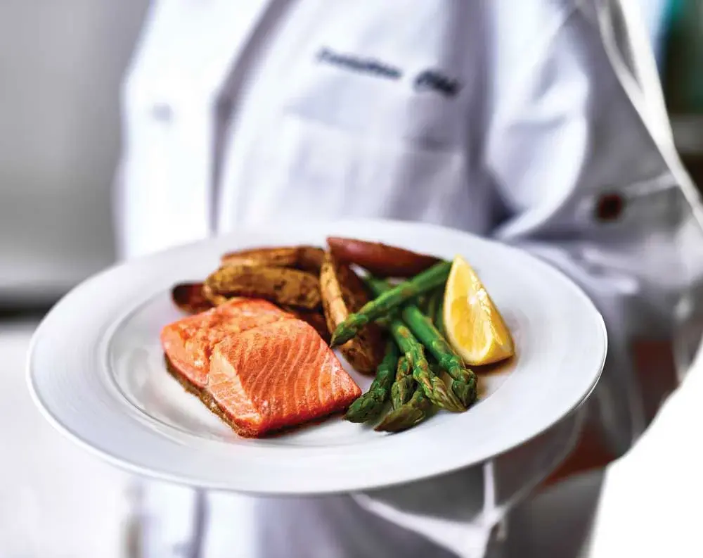 Parker Place Chef Created Meals, chef delivering a finished dish.